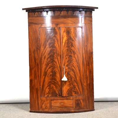 Lot 493 - Late Georgian mahogany bowfront hanging corner cupboard