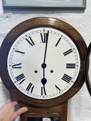 Lot 558 - An oak cased wall clock.