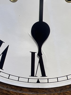 Lot 558 - An oak cased wall clock.