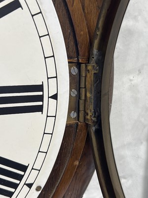 Lot 558 - An oak cased wall clock.