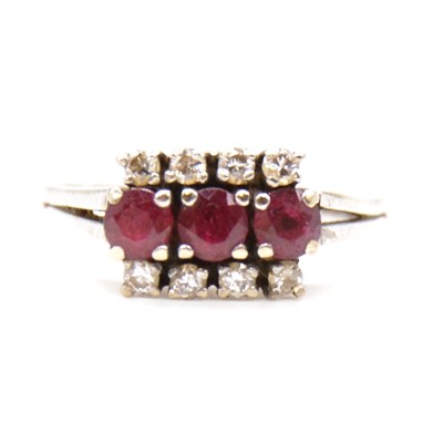 Lot 48 - A ruby and diamond triple row ring.