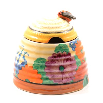 Lot 11 - A Clarice Cliff Bizarre preserve/honey pot and cover in the Gayday pattern.