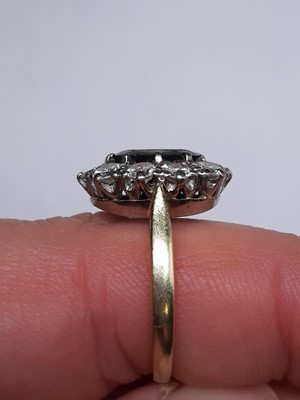 Lot 42 - A sapphire and diamond oval cluster ring