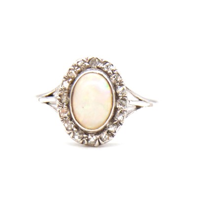 Lot 70 - An opal and diamond cluster ring.