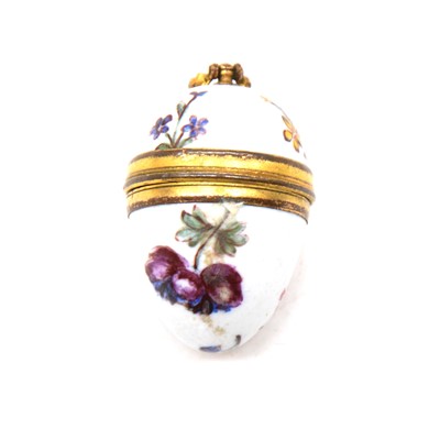 Lot 215 - An enamelled egg pendant with miniature bone egg and chick inside.