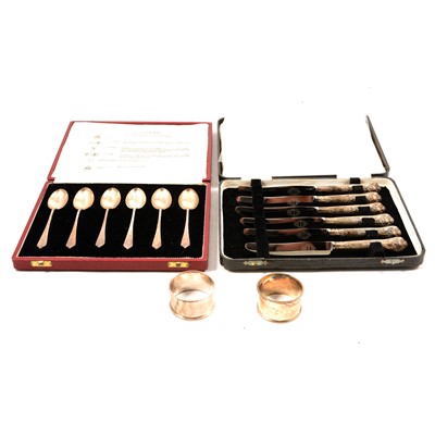 Lot 259 - A cased set of silver teaspoons, silver handled tea knives, two napkin rings.