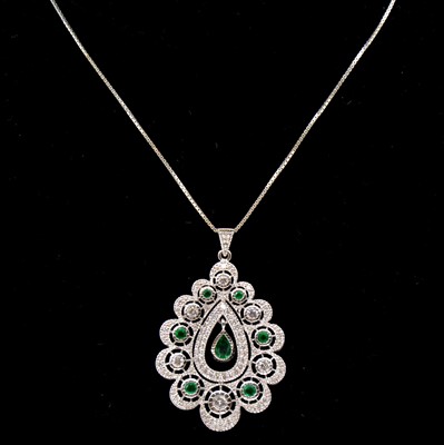 Lot 207 - A diamond and emerald pendant and chain.