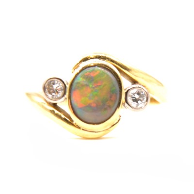 Lot 69 - A natural black opal and diamond dress ring.