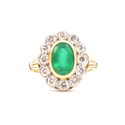 Lot 34 - An emerald and diamond cluster ring.