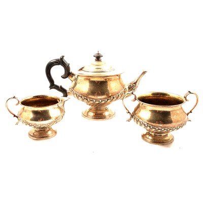 Lot 274 - A silver three piece teaset, half fluted.