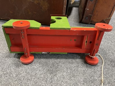 Lot 85 - Two vintage small suitcases, seven stained pine trays (possibly type trays), and a vintage pull-along train.