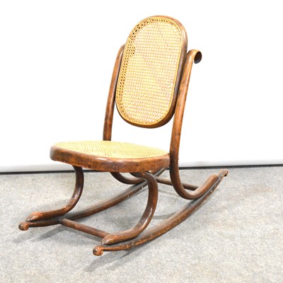 Lot 521 - A child's rattan cane rocking chair