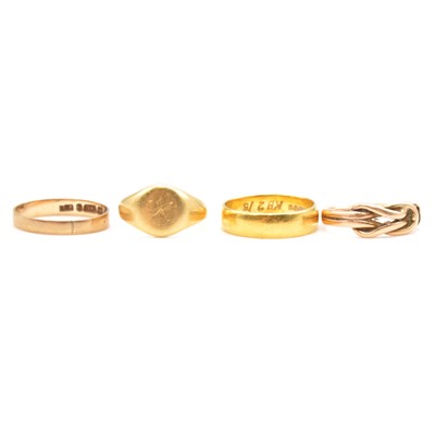 Lot 103 - Four gold rings, three wedding, knot.