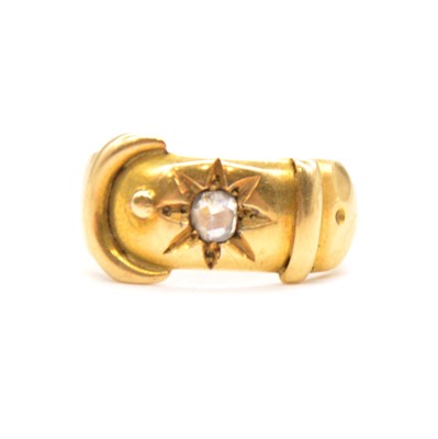 Lot 92 - A yellow gold buckle ring set with a rose cut diamond.