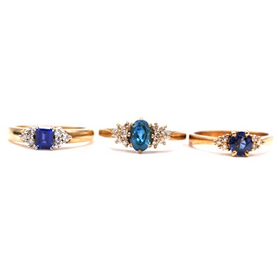 Lot 83 - Two synthetic sapphire and diamond rings and a blue topaz and diamond ring.