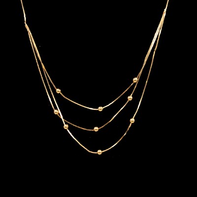 Lot 198 - A yellow metal necklace, three strands to front with beads