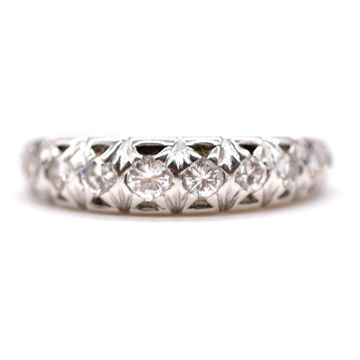 Lot 63 - A diamond half eternity ring.