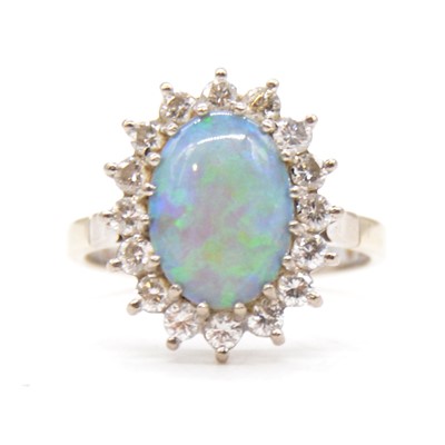 Lot 68 - A opal and diamond cluster ring.
