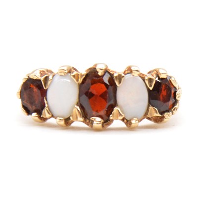 Lot 73 - A garnet and opal half hoop ring.