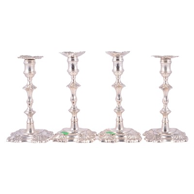 Lot 33 - Set of four George II cast silver candlesticks