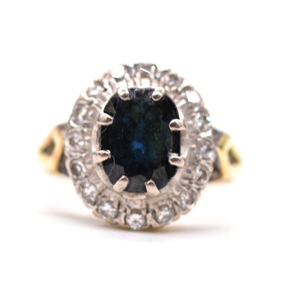 Lot 61 - A sapphire and diamond cluster ring.