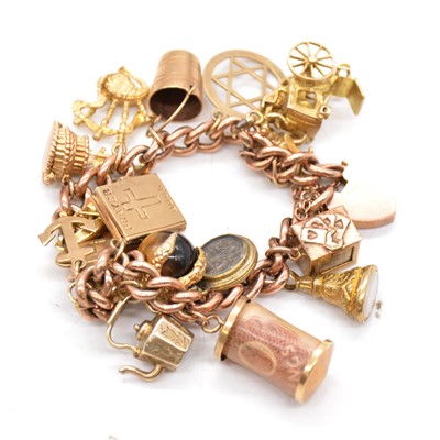 Lot 173 - A gold charm bracelet with charms.