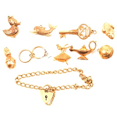 Lot 260 - A 9 carat yellow gold hollow curb link bracelet and nine charms.