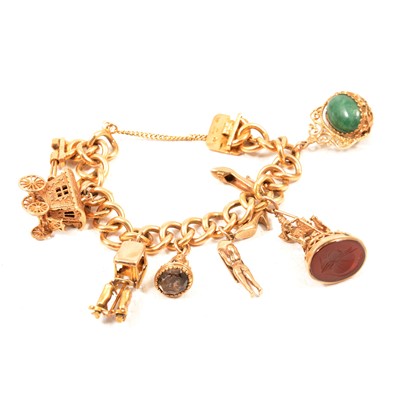 Lot 182A - A 18 carat gold charm bracelet with seven 9 carat gold charms