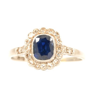 Lot 46 - A sapphire and diamond cluster ring.