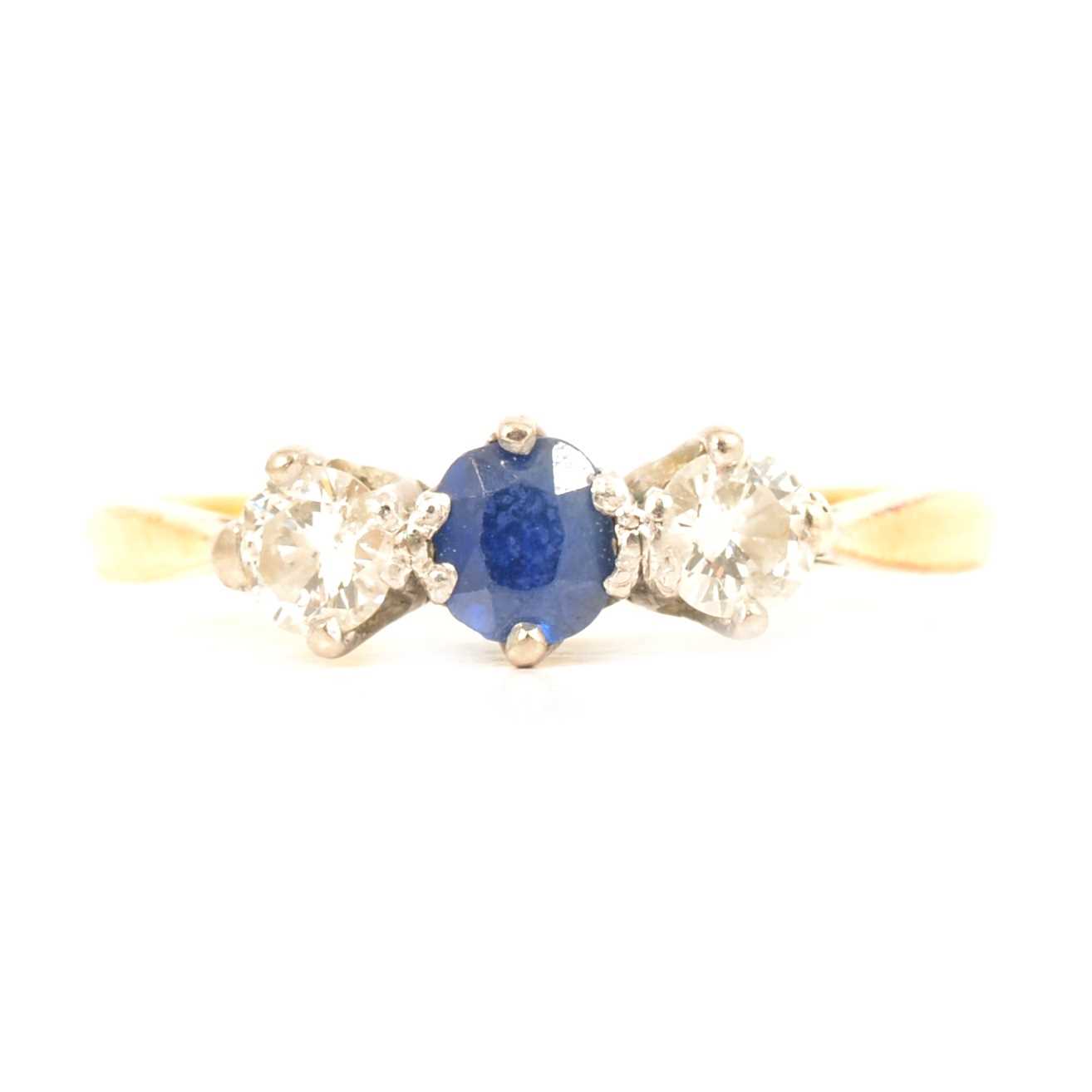 Lot 19 - A sapphire and diamond three stone ring.