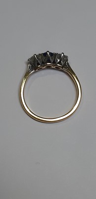Lot 19 - A sapphire and diamond three stone ring.