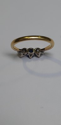 Lot 19 - A sapphire and diamond three stone ring.