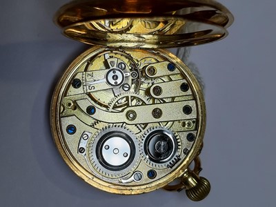 Lot 323 - An 18 carat gold open face pocket watch and metal Albert watch chain.