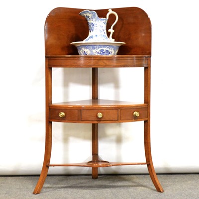 Lot 482 - George III mahogany corner washstand, with jug and bowl