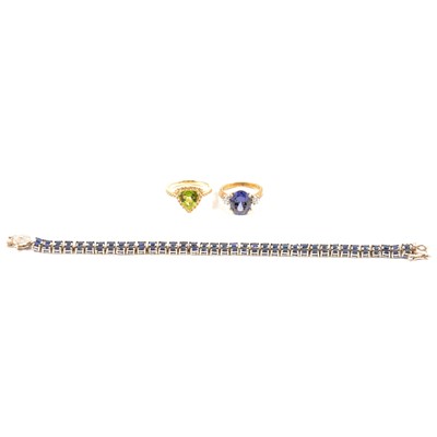 Lot 402 - A sapphire tennis bracelet and two gilt white metal gemset rings.