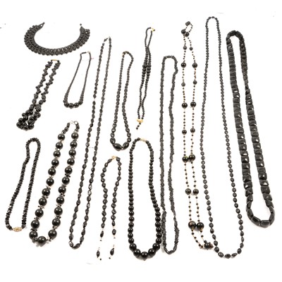 Lot 488 - Fourteen mixed material jet style necklaces.