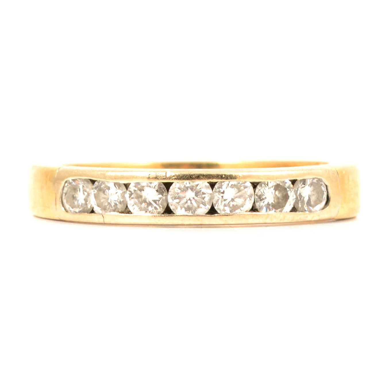 Lot 65 - A diamond half hoop ring.