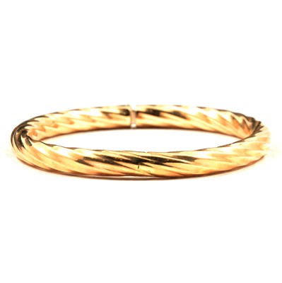 Lot 246 - A modern 9 carat yellow gold bangle.