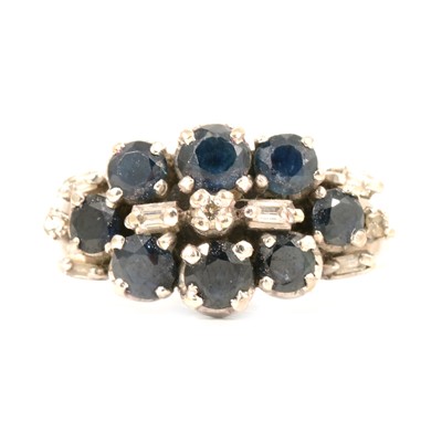 Lot 45 - A sapphire and diamond cluster ring.