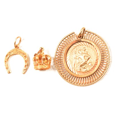 Lot 202 - A 9 carat yellow gold St Christopher, two gold charms.