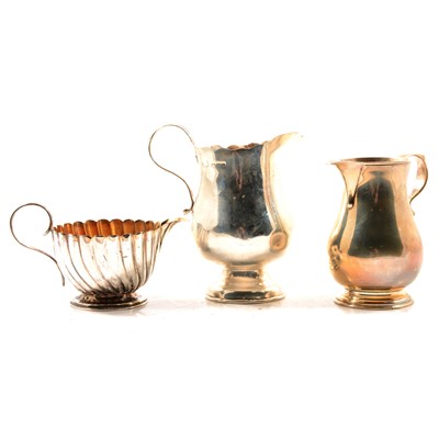 Lot 320 - Three silver cream jugs