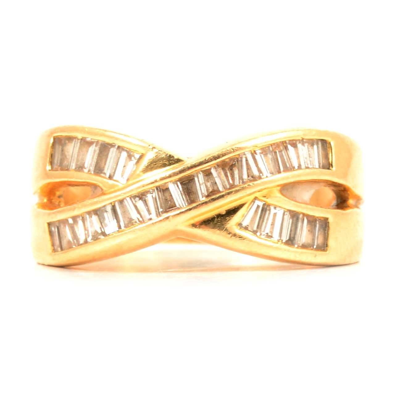 Lot 110 - A diamond crossover ring.