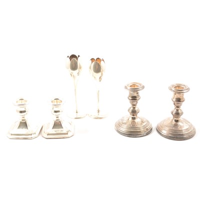 Lot 219 - Two pairs of silver candletsicks, and a pair of bud vases (weighted)