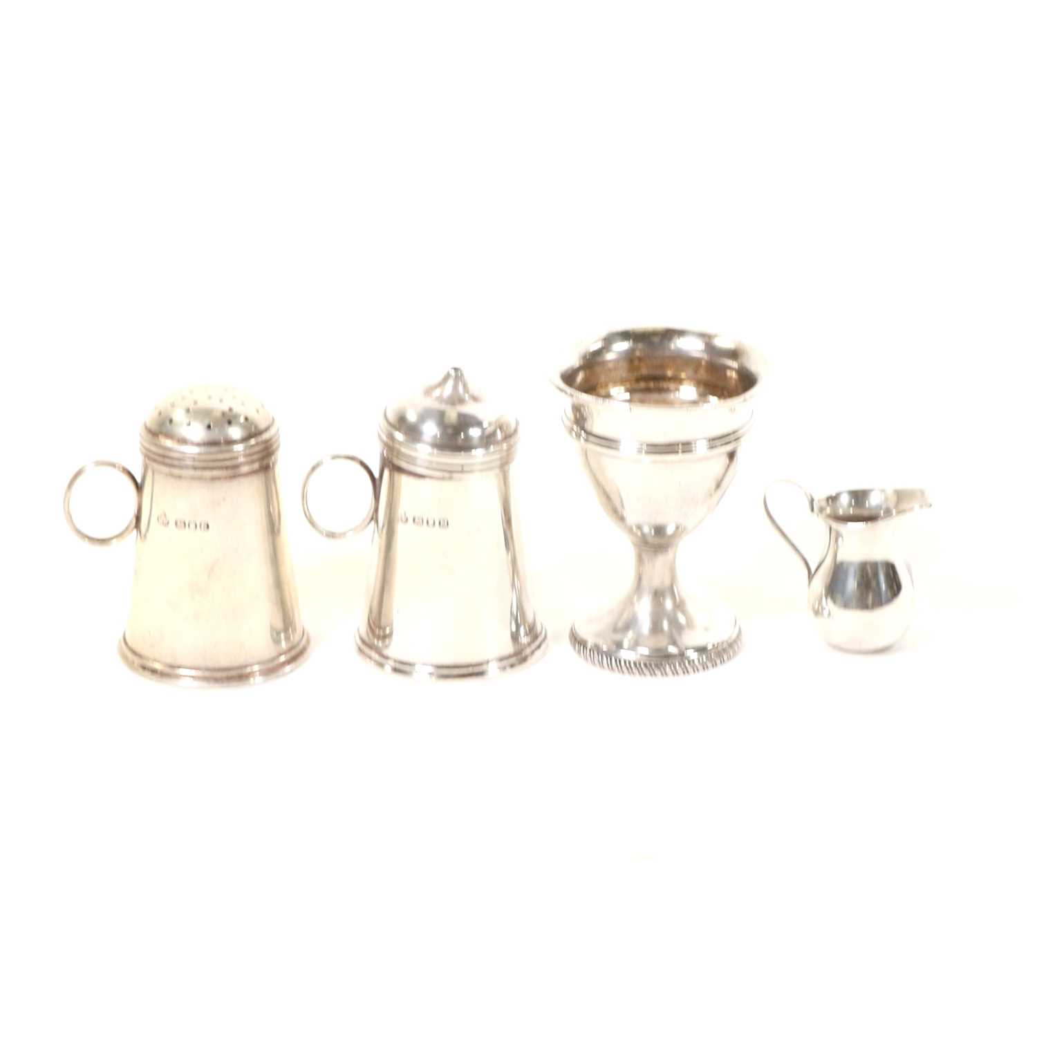 Lot 715 - George III silver egg cup, dredger type salt and pepper and a miniature jug