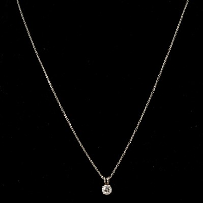 Lot 173 - A diamond solitaire pendant and chain.