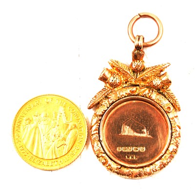 Lot 135 - A 9 carat gold engraved football medal and a 9 carat replica coin.