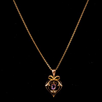 Lot 190 - An Edwardian amethyst and seed pearl pendant and chain.