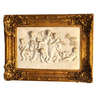 Lot 139 - Two marble-effect composite relief panels in gilt frames