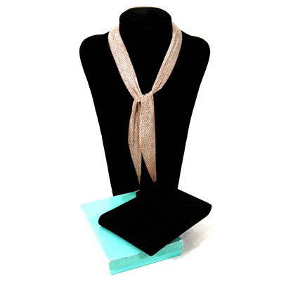 Lot 404 - Elsa Peretti for Tiffany - a silver mesh scarf necklace with case and box.