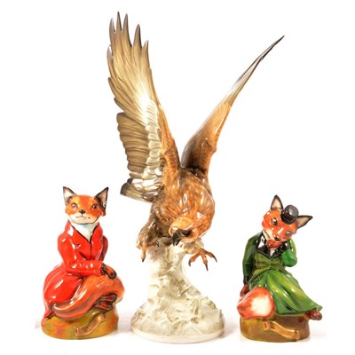 Lot 90 - German porcelain model of an eagle, and two English ceramic fox figures